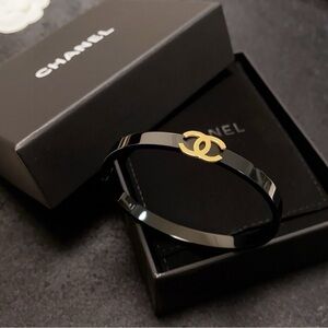 CHANEL Black Bangle with Gold Emblem